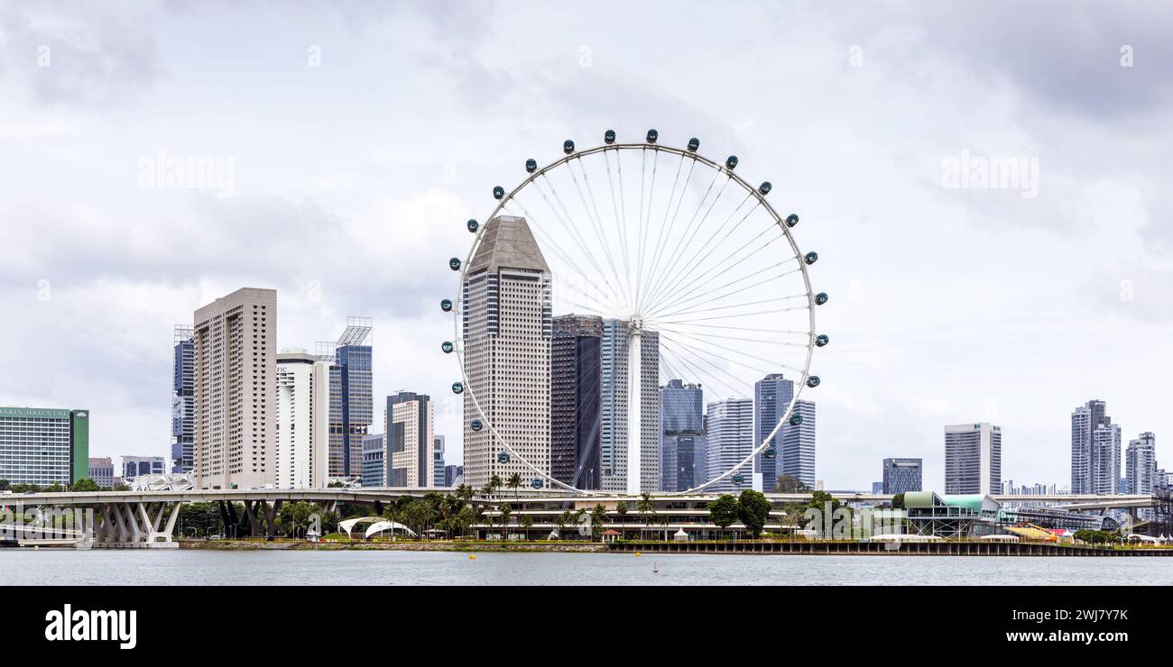 Marina Bay et les gratte-ciel du centre de Singapour avec la roue d'observation Singapore Flyer Banque D'Images