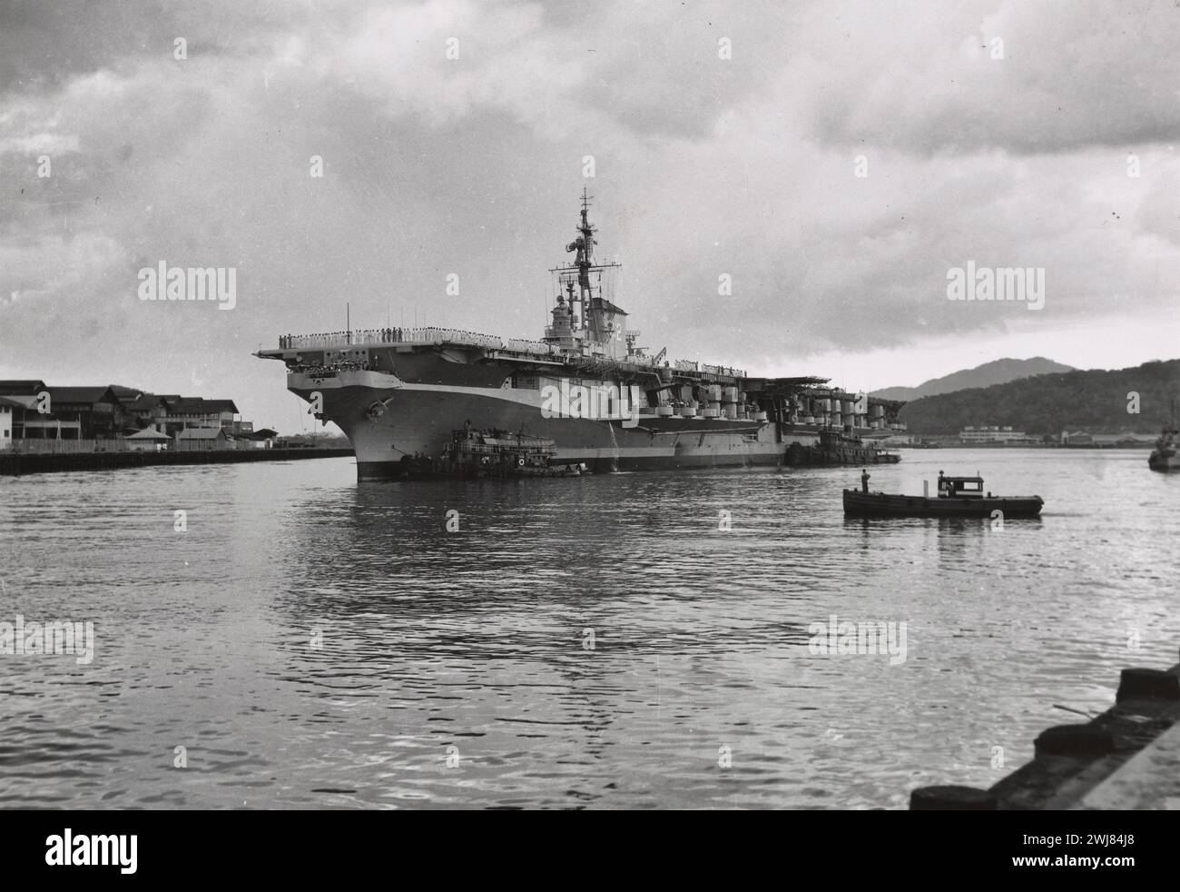 Remorqueurs guident l'USS F d Roosevelt dans son poste d'amarrage à l'embarcadère 17, Balboa, zone du canal de Panama, 1954 Banque D'Images