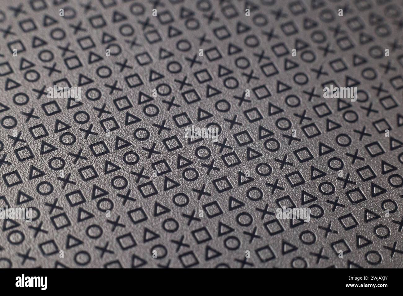 Motif de symboles et de signes sur une surface grise plate Banque D'Images