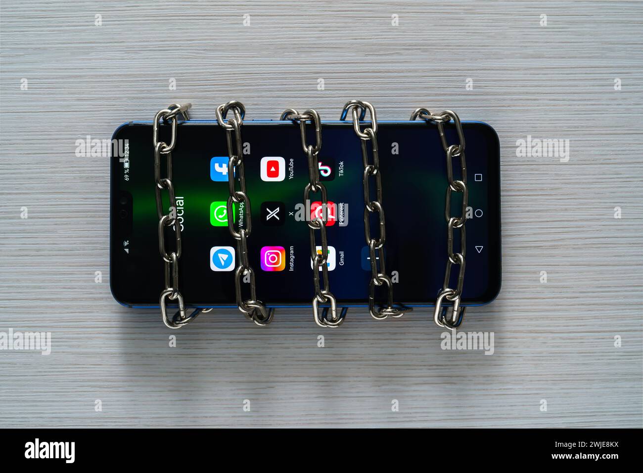 Ouzbékistan, Tachkent - 27 janvier 2024 : chaîne sur un téléphone mobile avec des icônes de réseau social sur elle. Le concept de limitation du temps sur les réseaux sociaux, Banque D'Images