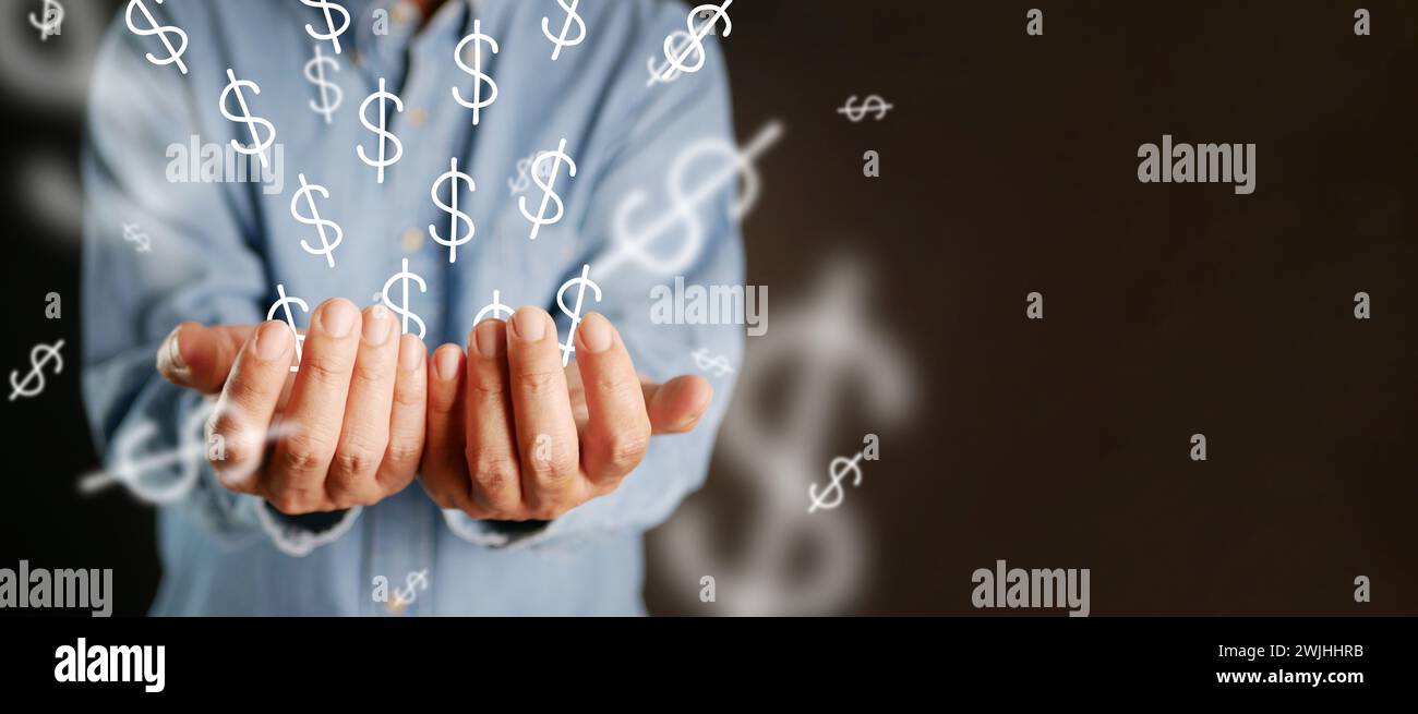 Beaucoup de signes de dollar jaillissent de la main d'un homme d'affaires. L'idée d'affaires fait de l'argent, des idées créatives réussies pour l'entrepreneur d'affaires. Un homme tient un Banque D'Images