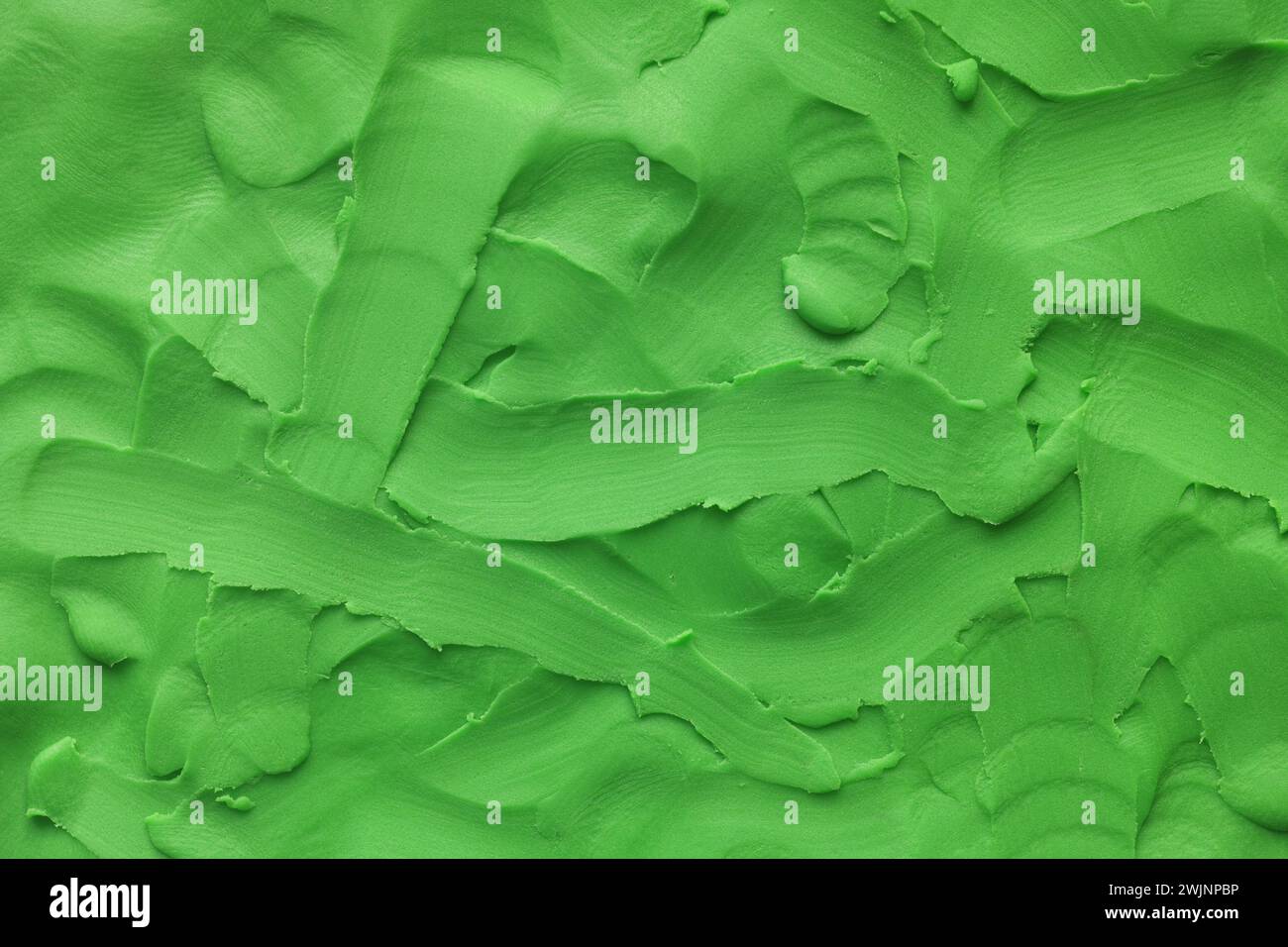 Une texture de fond faite d'argile de jeu verte. Gros plan. Banque D'Images