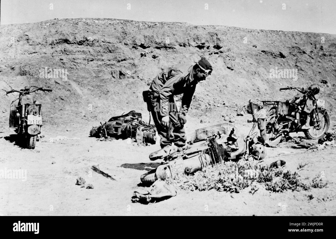 Équipement Axis capturé en Tunisie -- Un soldat américain examine des motos italiennes abandonnées précipitamment par les forces de l'axe qui fuyaient avant une attaque de l'armée américaine en Tunisie. 21 juin 1943. (Photo du U.S. Office of War information Picture). Banque D'Images