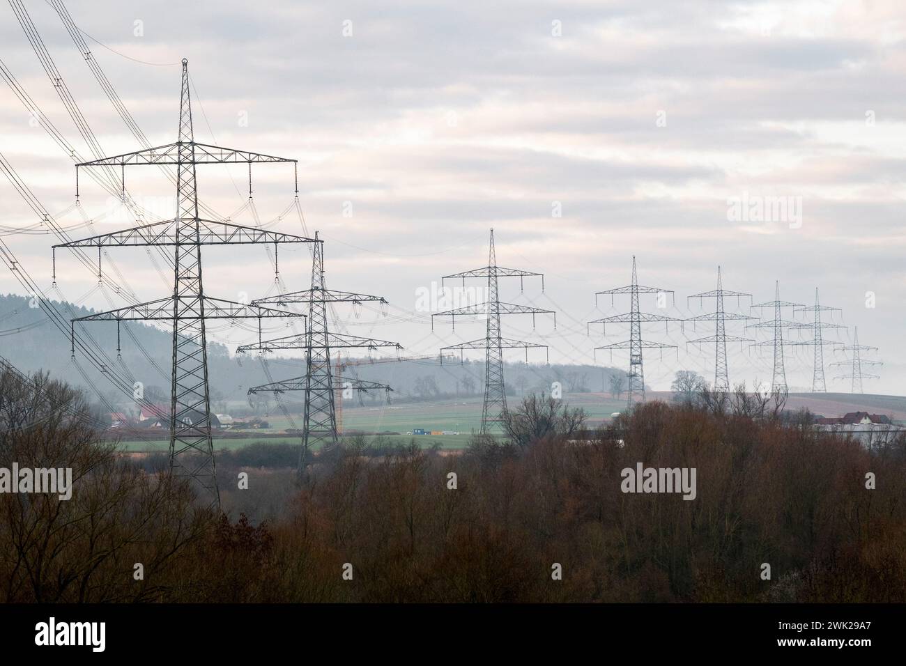 Redwitz, Allemagne. 18 février 2024. Pylônes électriques à l'aube. Ils font partie du pont électrique de Thuringe avec des lignes à très haute tension. Crédit : Daniel Vogl/dpa/Alamy Live News Banque D'Images