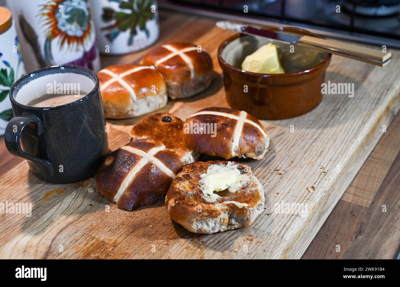 Brioches Hot Cross grillées au beurre un plat traditionnel du petit déjeuner mangé à Pâques Banque D'Images