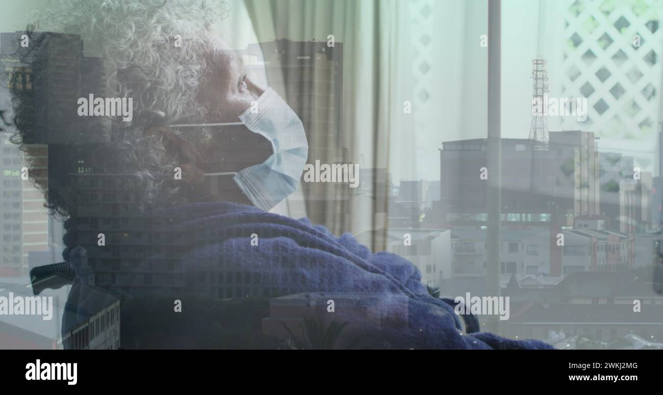 Image d'un paysage urbain au-dessus d'une femme afro-américaine handicapée assise en fauteuil roulant Banque D'Images