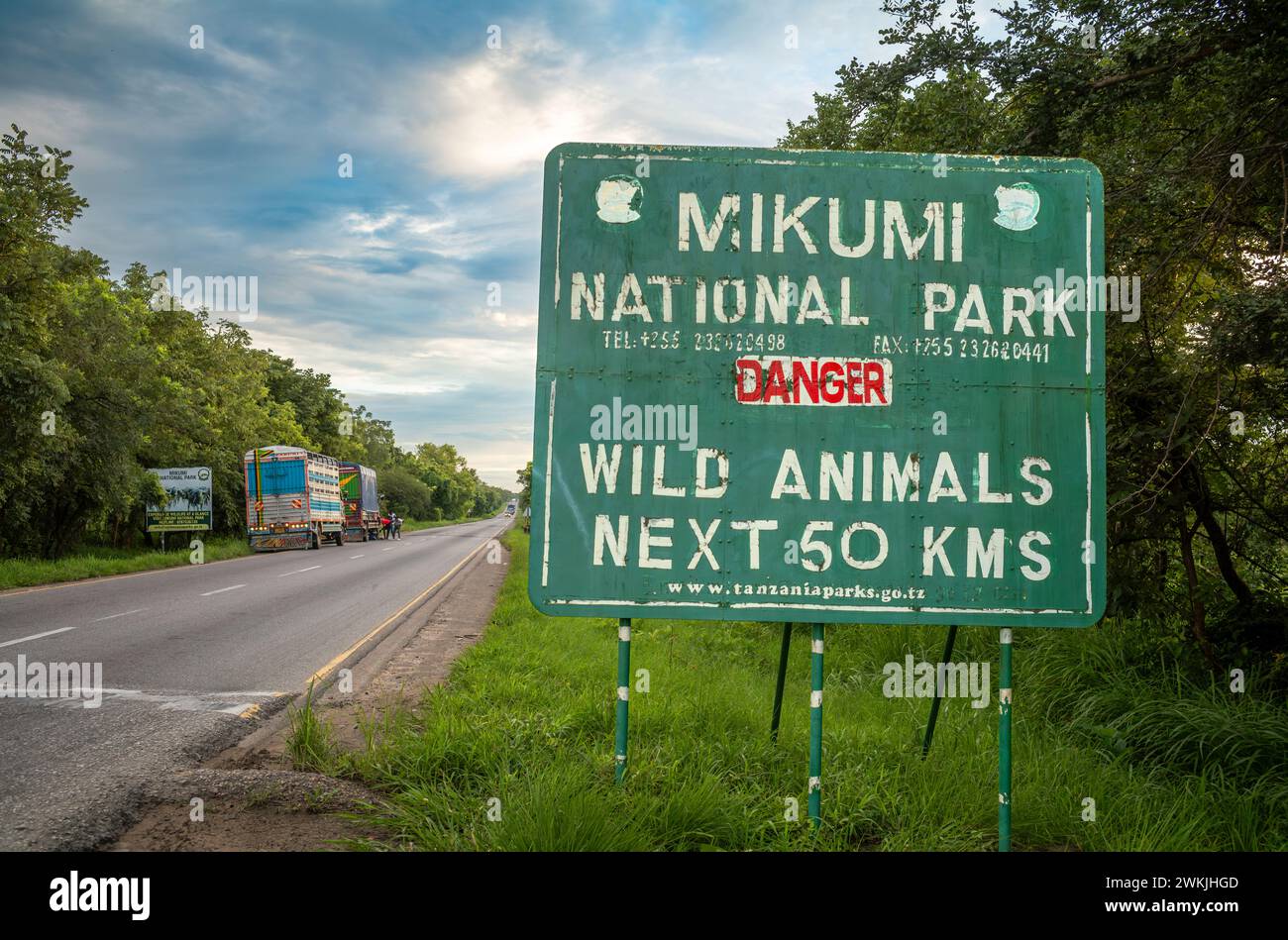 Camions sur le côté de l'autoroute A7 près du panneau d'entrée du parc national de Mikumi en Tanzanie Banque D'Images