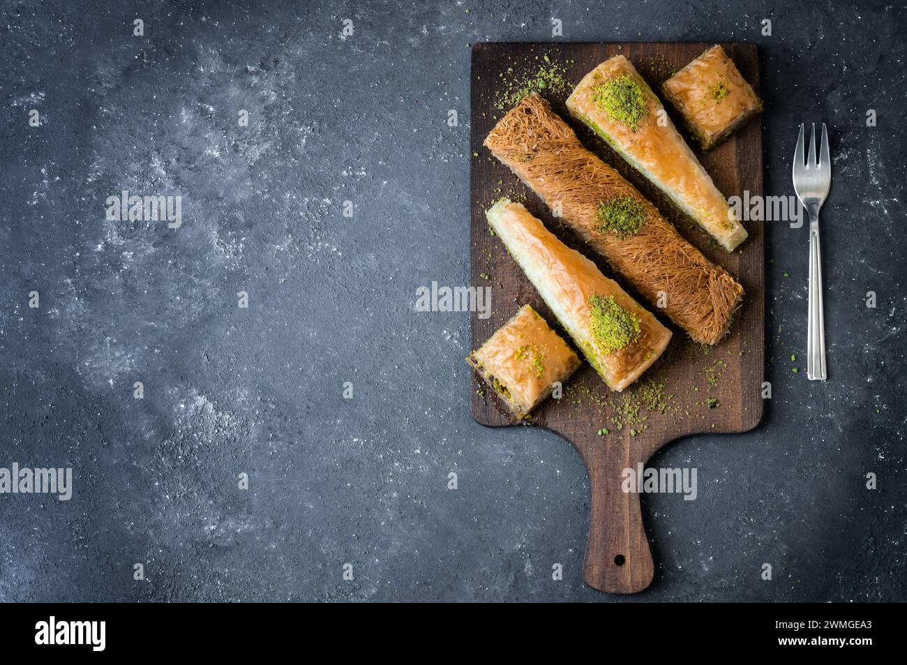 Concept traditionnel de dessert turc, kadayif, tranche de carrotte, baklava antep avec pistache sur fond rustique Banque D'Images