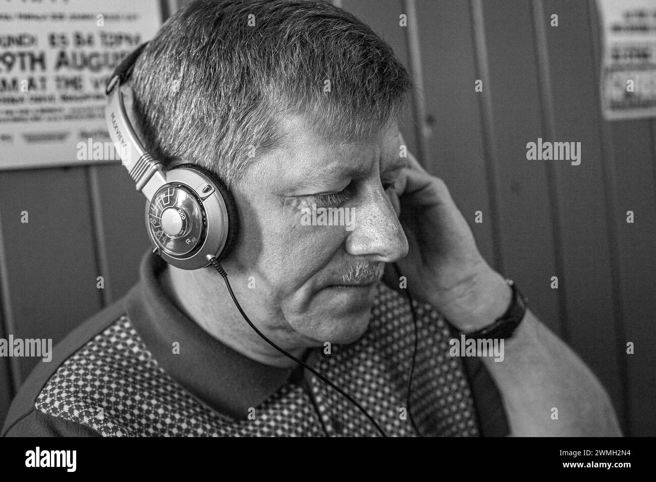 Homme mature écoutant de la musique sur des écouteurs. Banque D'Images