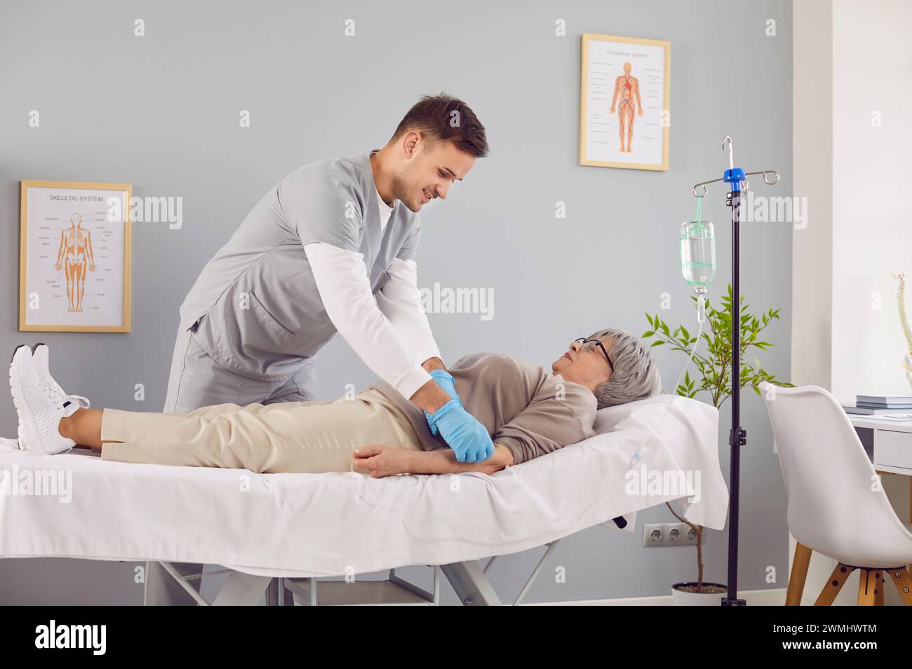 Patient âgé malade allongé sur le canapé à l'hôpital recevant une perfusion intraveineuse. Banque D'Images