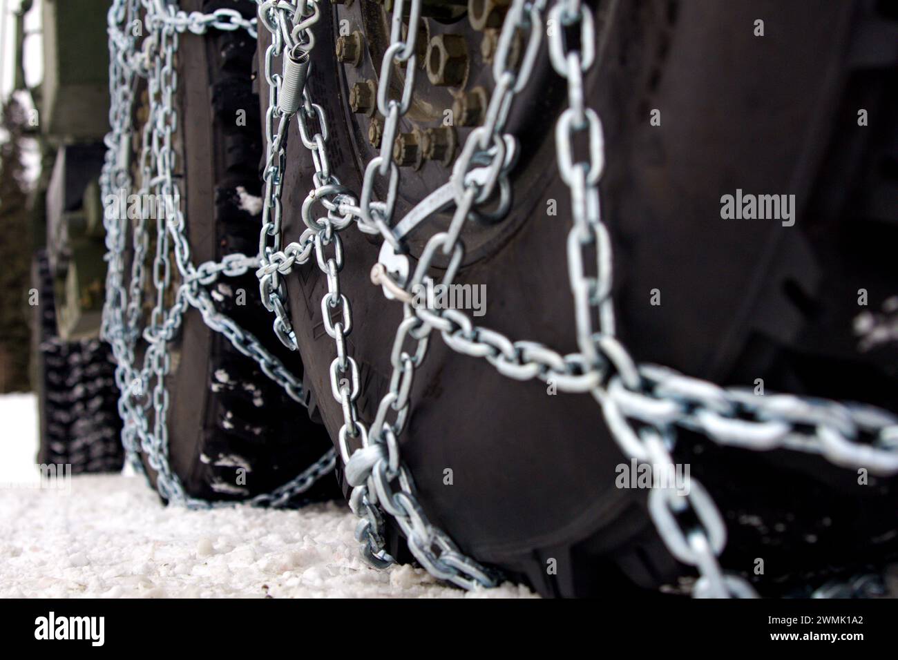 Les Marines américains avec Fox Battery, 2e Bataillon, 14e Régiment de Marines, 4e Division des Marines, réserve des Forces marines attachent des chaînes à neige aux pneus d'un véhicule HIMARS (High Mobility Artillery Rocket System) lors de l'exercice Arctic Edge 2024 à la base aérienne d'Eielson, Alaska, le 22 février 2024. Le système d'armes HIMARS est un élément crucial de l'élément de combat au sol de la Marine Air-Ground Task Force (MAGTF). Les HIMARS jouent un rôle central dans la fourniture de feux de précision à longue portée pour soutenir les objectifs du MAGTF, des opérations expéditionnaires aux combats soutenus sur tous les terrains et tous les climats. Arctic Edge Banque D'Images