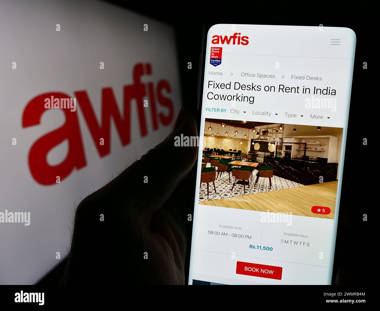 Personne tenant le téléphone portable avec la page Web de la société indienne d'espace de travail Awfis Space solutions Limited avec le logo. Concentrez-vous sur le centre de l'écran du téléphone. Banque D'Images