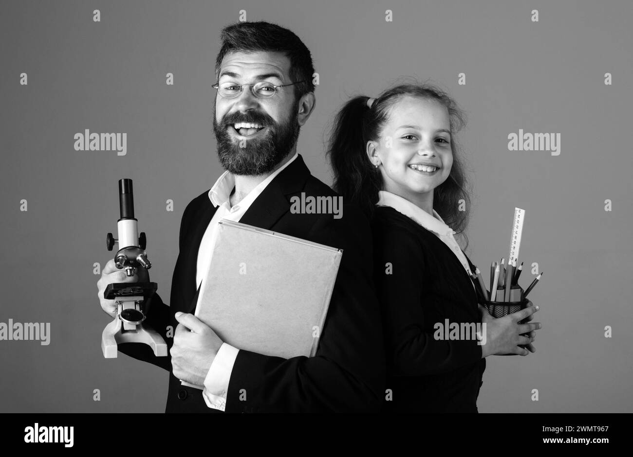 Professeur émerveillé avec une jeune fille heureuse et excitée.Portrait d'une jeune fille étudiante drôle et d'un tuteur avec des fournitures scolaires.Bonne enseignante et fille étudiante Banque D'Images