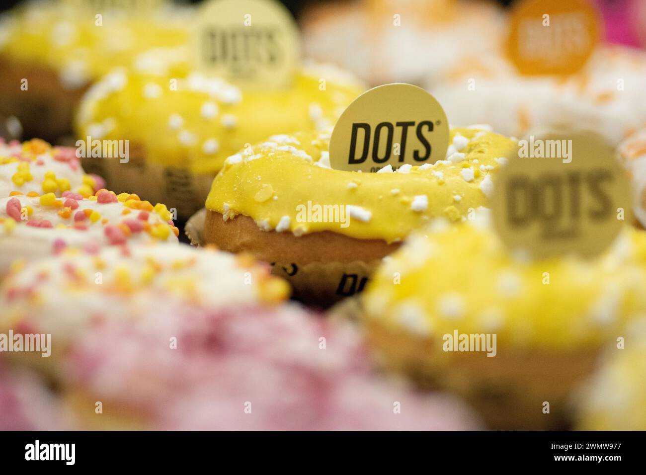 Un tas de beignets colorés avec des étiquettes dessus Banque D'Images