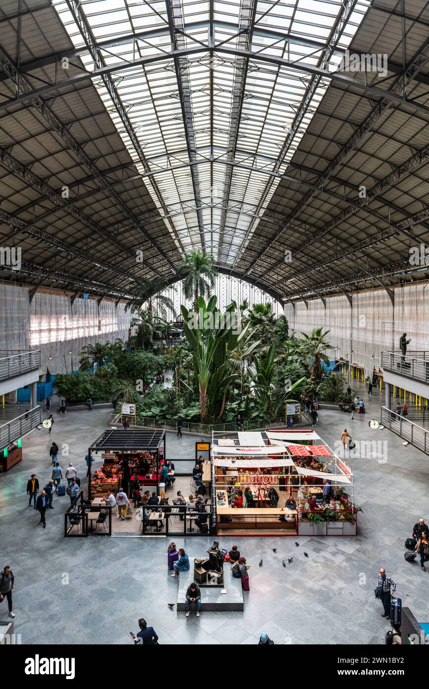 MADRID, ESPAGNE - 23 MARS 2023 : voyageurs dans le jardin tropical de la gare d'Atocha, Madrid, Espagne. Banque D'Images