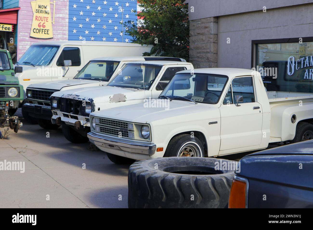 camions à plateau vintage des années 1970 dans une ligne à l'extérieur du garage route 66 Banque D'Images