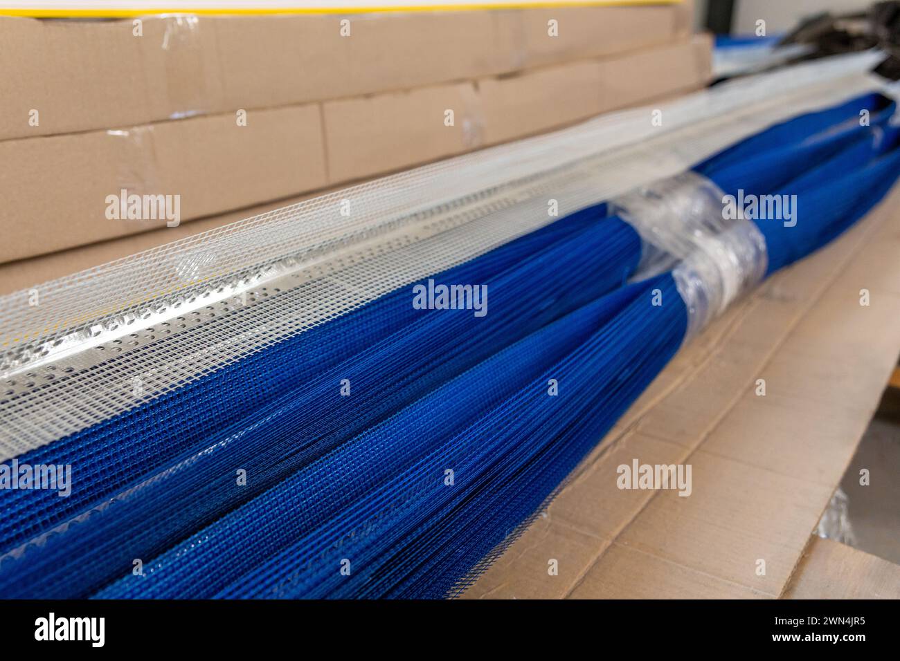 Perles d'angle perforées en aluminium avec grille PVC sur le marché des matériaux de construction Banque D'Images