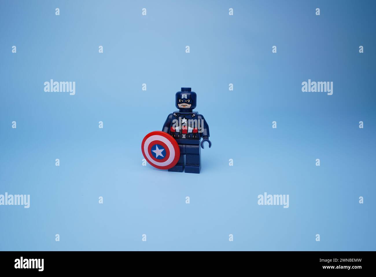 Un Lego Captain America isolé sur un fond bleu vide Banque D'Images