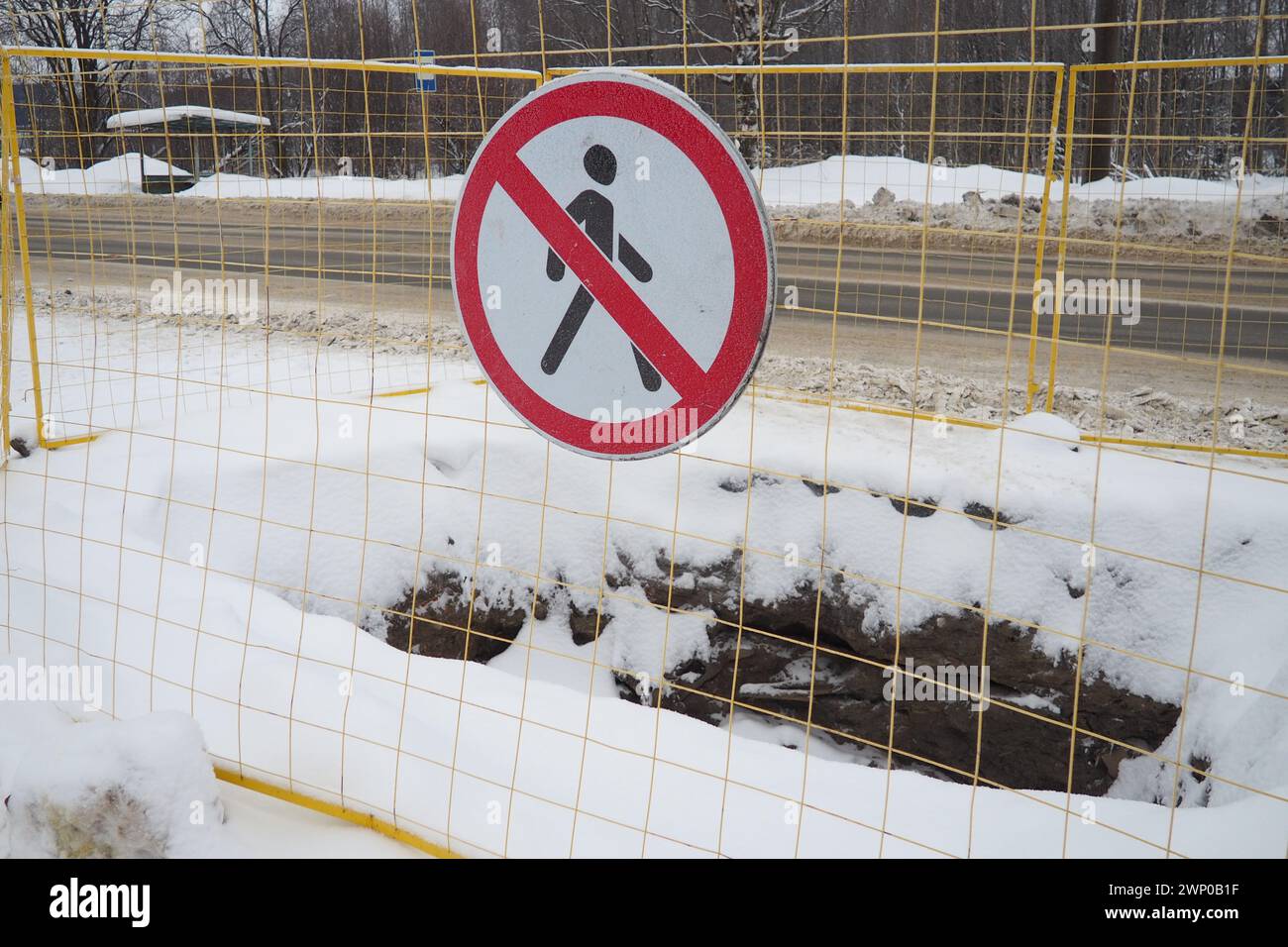 Pas de panneau de passage, ne pas passer. Homme barré avec une ligne rouge. Signalisation routière circulaire interdite. Interdit. Un trou creusé dans le sol, entouré d'un métal Banque D'Images