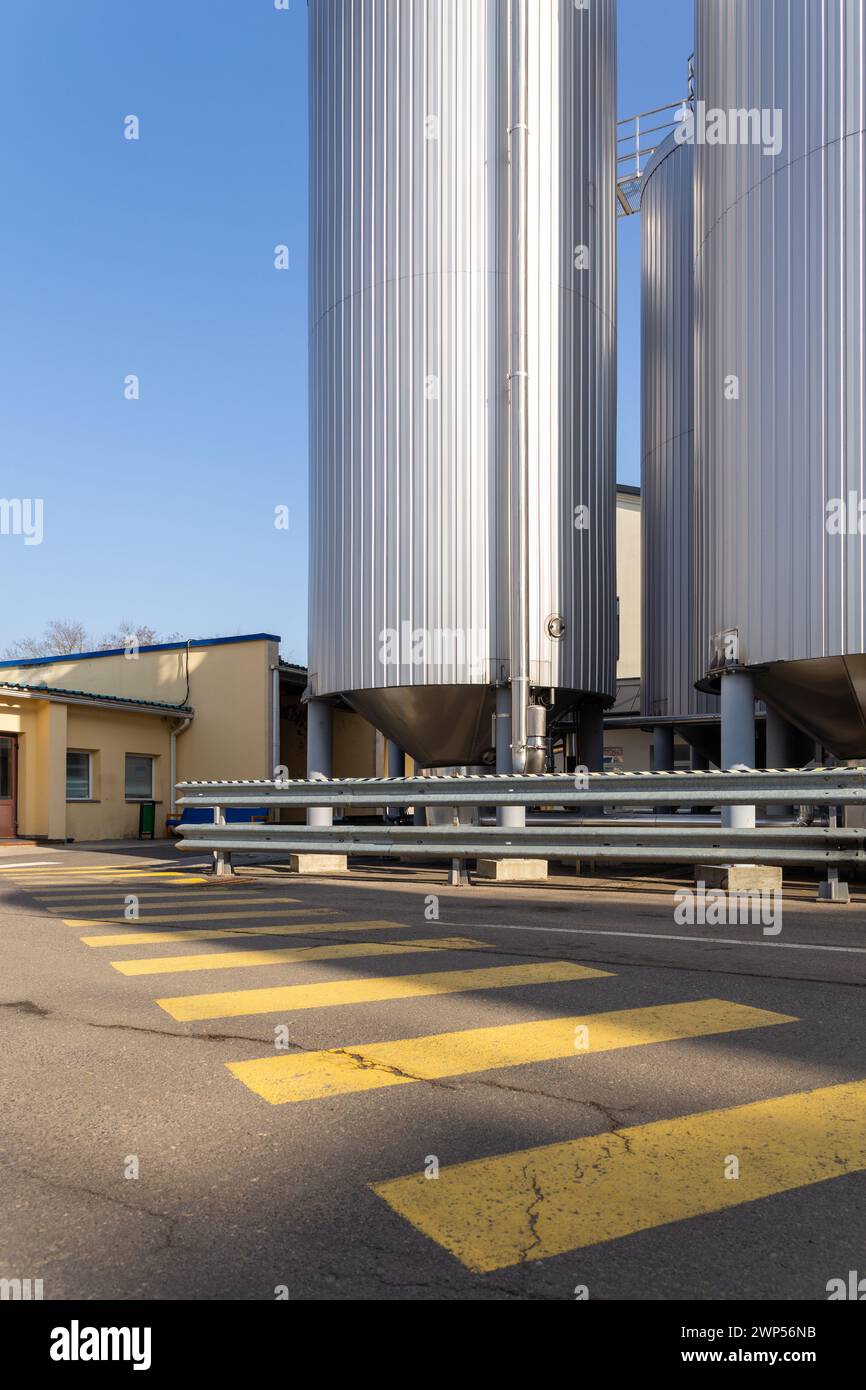 Les silos ou réservoirs de brasserie sont généralement utilisés pour stocker de l'orge ou de la bière fermentée. Équipement de brasserie extérieur avec réservoirs et tuyaux en acier inoxydable. Banque D'Images