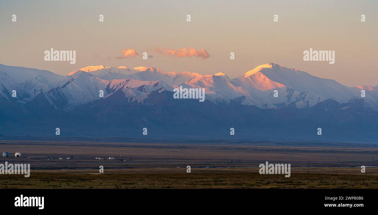 Panorama paysager sur la chaîne enneigée TRANS-Alay et Lenin Peak au lever du soleil avec alpenglow, Sary Tash, Kirghizistan Banque D'Images