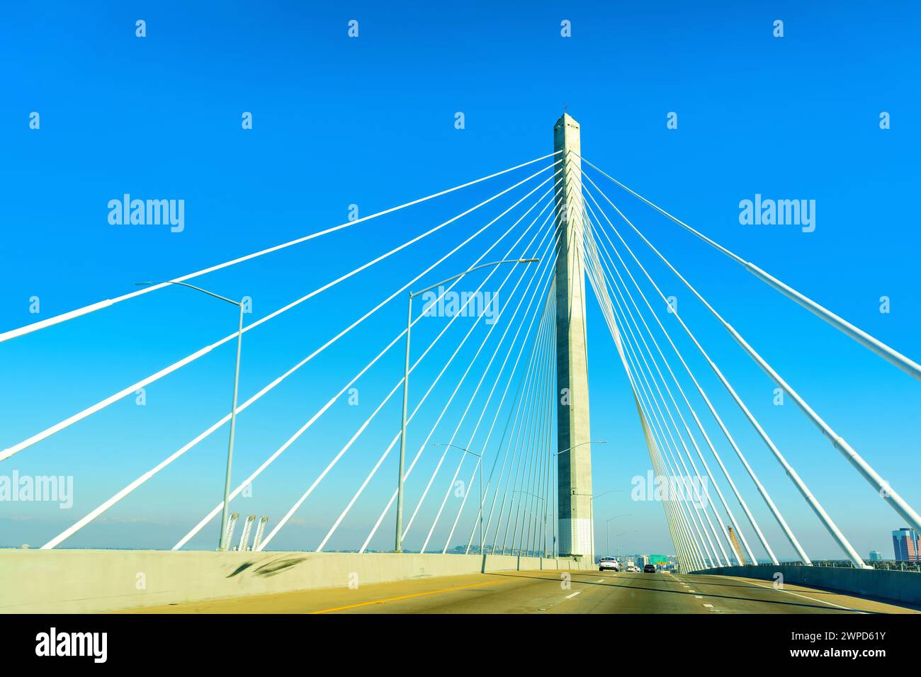 Vue dynamique capturée lors de la conduite sur le pont Gerald Desmond, avec une perspective grand angle des haubans de câble et une tour unipolaire contre eux Banque D'Images