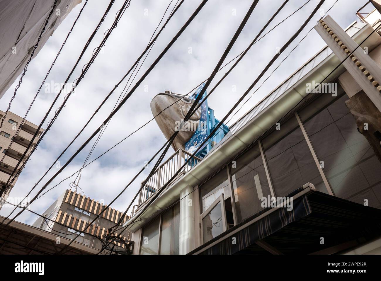 Tokyo- Japon- vers novembre 2018. Vue d'une rue au marché aux poissons de Tsukiji avec des câbles d'air typiques et grande figure de poisson Adverese Banque D'Images