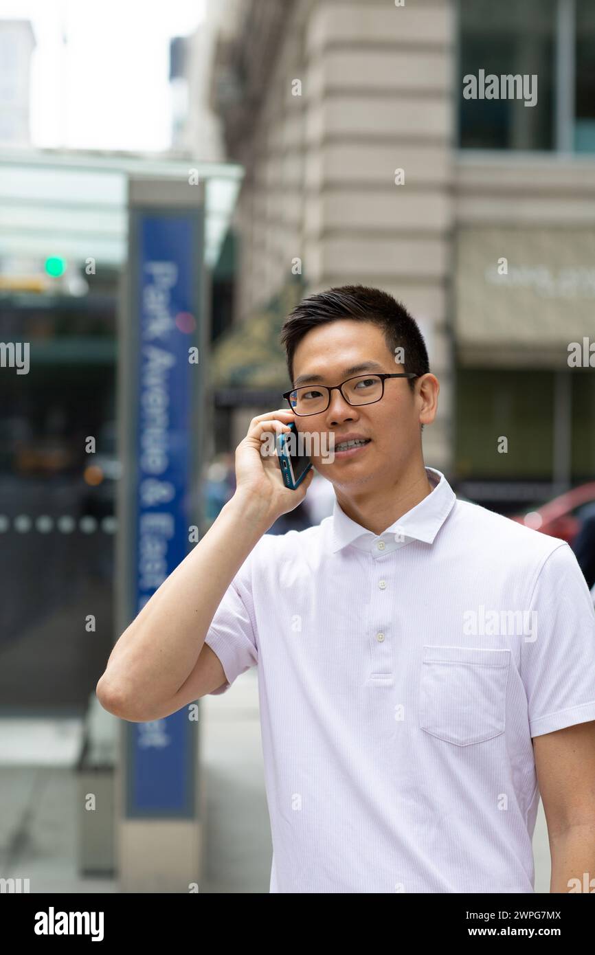 Chinese businessman talking on cell phone Banque D'Images