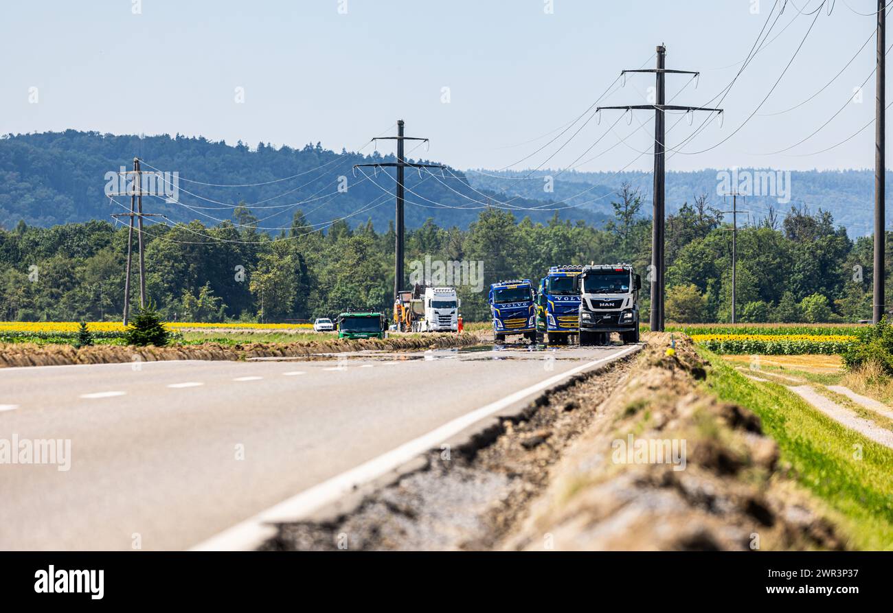 Die Lastwagen reihen sich aneinander. Der abgetragene Asphalt muss abgetragen werden. (Wil ZH, Schweiz, 15.07.2023) Banque D'Images