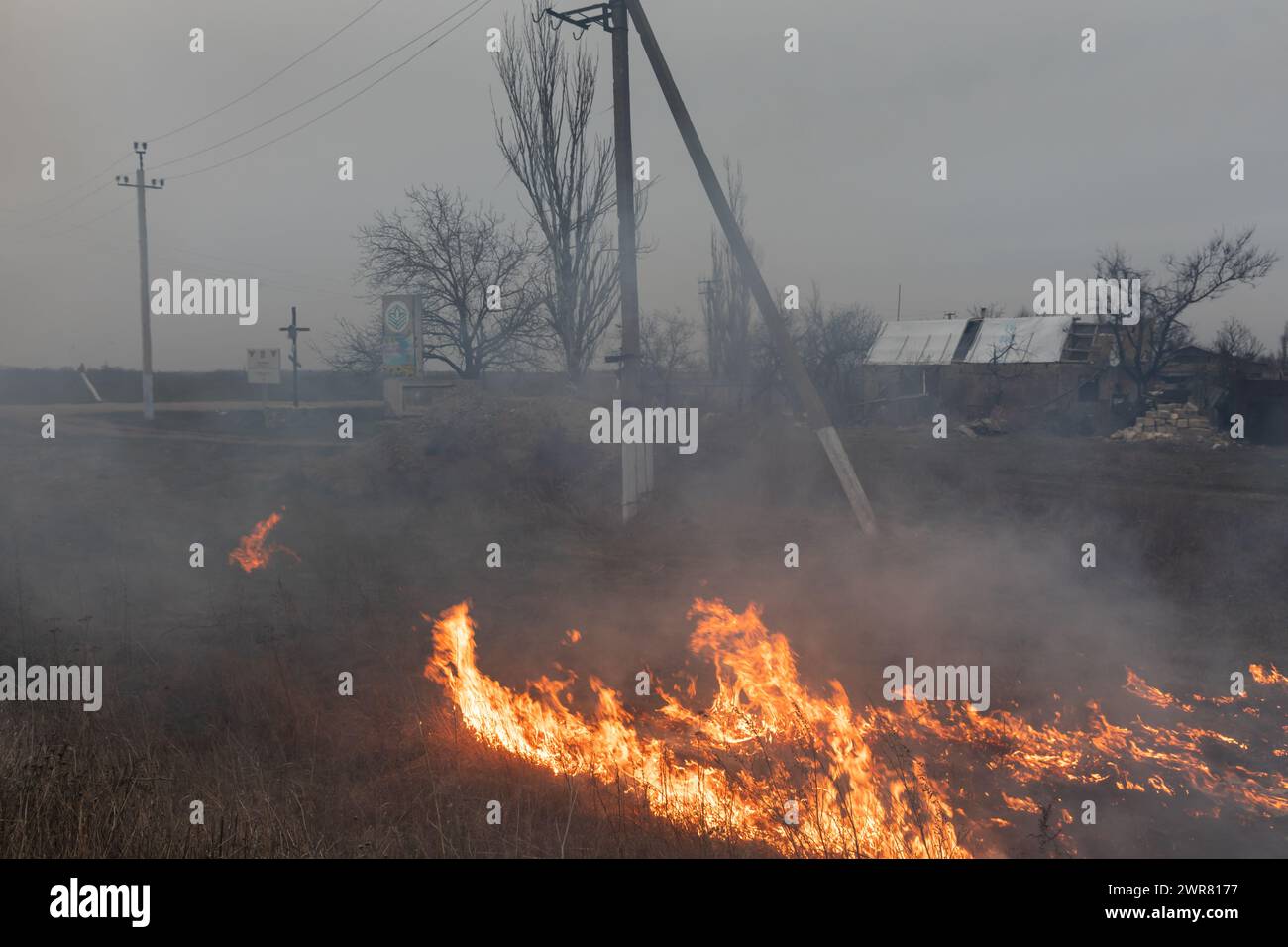 On voit de l'herbe en feu à la périphérie d'un village de la région de Mykolaiv en Ukraine. Une scène typique d'un village ukrainien dans la région de Mykolaïv, comme dans d'autres régions de l'Ukraine après l'occupation et près de la ligne de front. Bombardement régulier et destruction des maisons des résidents locaux. (Photo de Mykhaylo Palinchak / SOPA images/SIPA USA) Banque D'Images