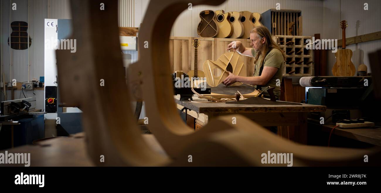 15/02/24 Rob Hodgson, 40 ans, fabrique des guitares dans son atelier à Idridgehay, près de Wirksworth, Derbyshire. Article complet : https://docs.google.com/document/d/ Banque D'Images