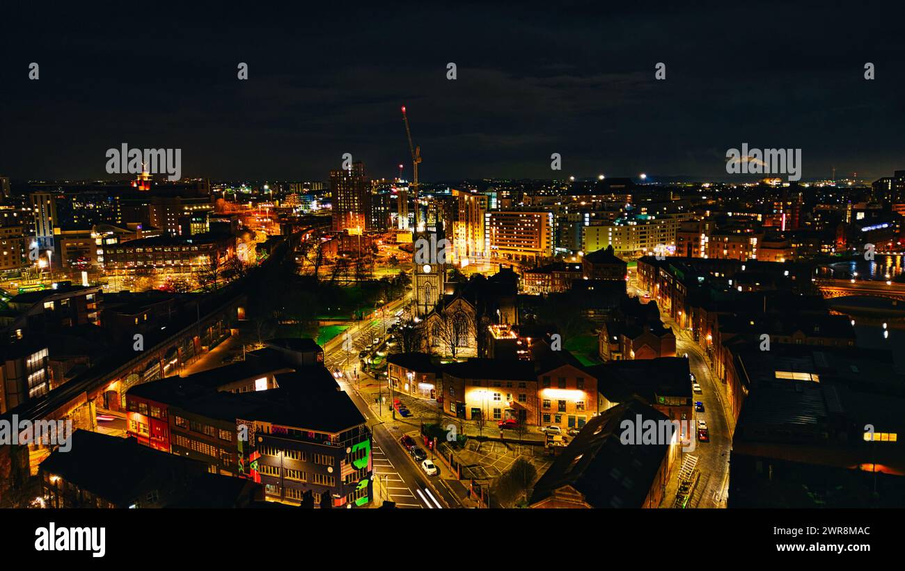 Paysage urbain nocturne avec rues et bâtiments illuminés, mettant en valeur la vie nocturne urbaine et l'architecture à Leeds, Royaume-Uni. Banque D'Images