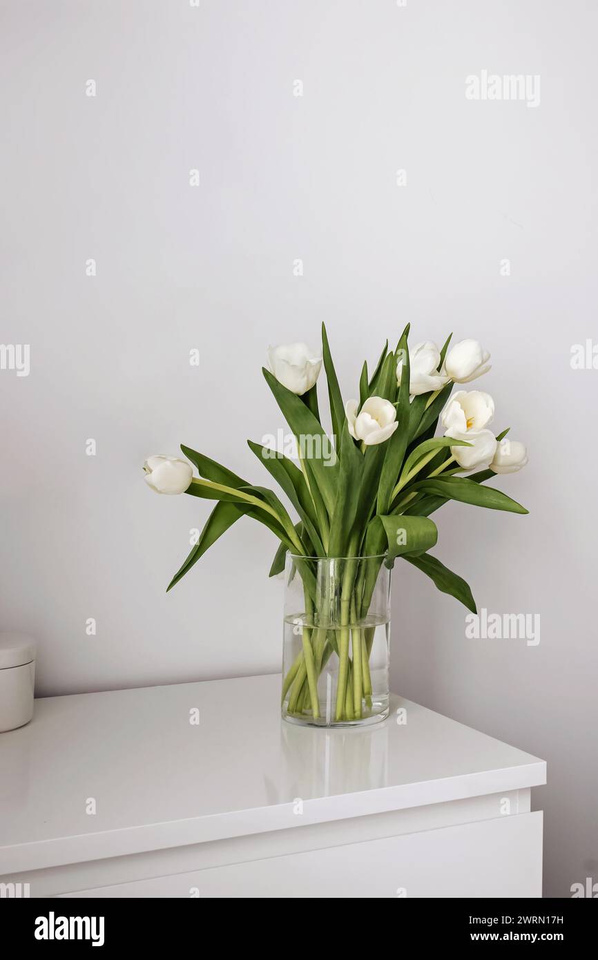 Tulipes blanches dans le vase, intérieur minimaliste Banque D'Images