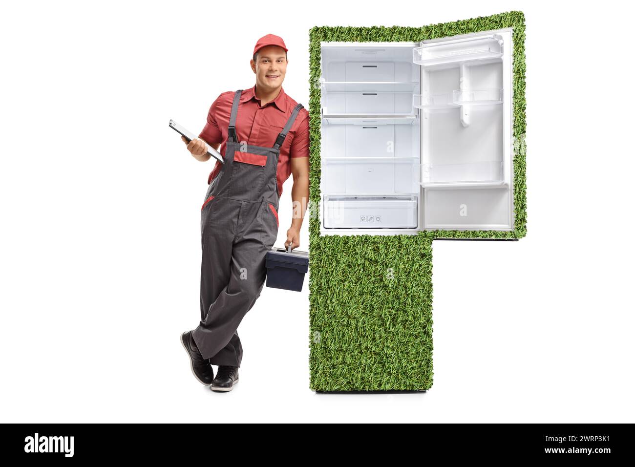 Réparateur avec une planchette à pince et une boîte à outils appuyée contre un réfrigérateur vert durable isolé sur fond blanc Banque D'Images