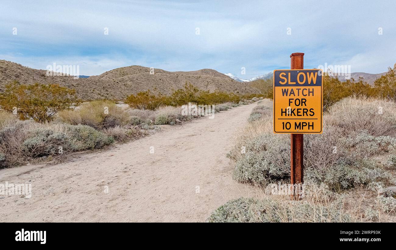 Un panneau le long d'un chemin de randonnée qui indique Slow Watch pour les randonneurs dans le désert Banque D'Images