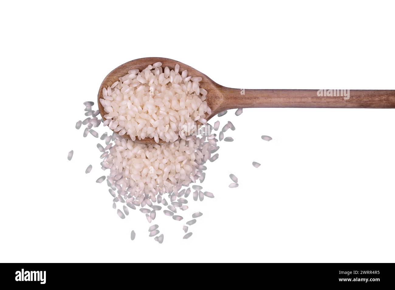 un tas de grains de riz sur une louche de bois Banque D'Images