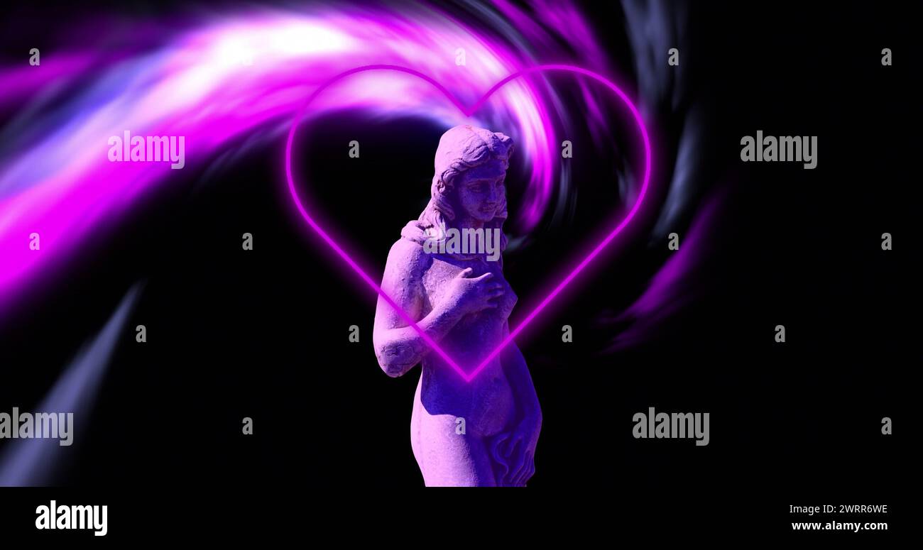 Une statue est enveloppée par un effet de lumière en forme de cœur rose fluo Banque D'Images