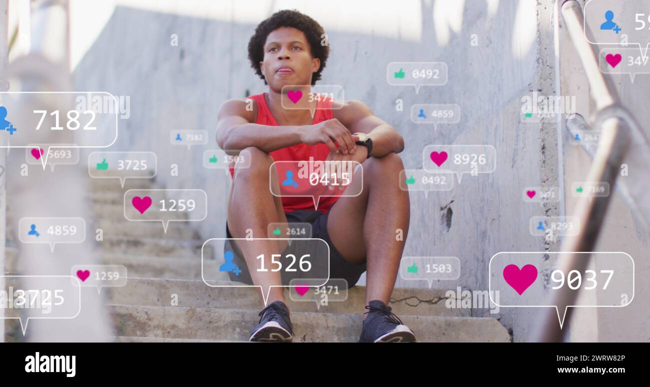 Image des icônes des médias au-dessus de l'homme afro-américain assis Banque D'Images