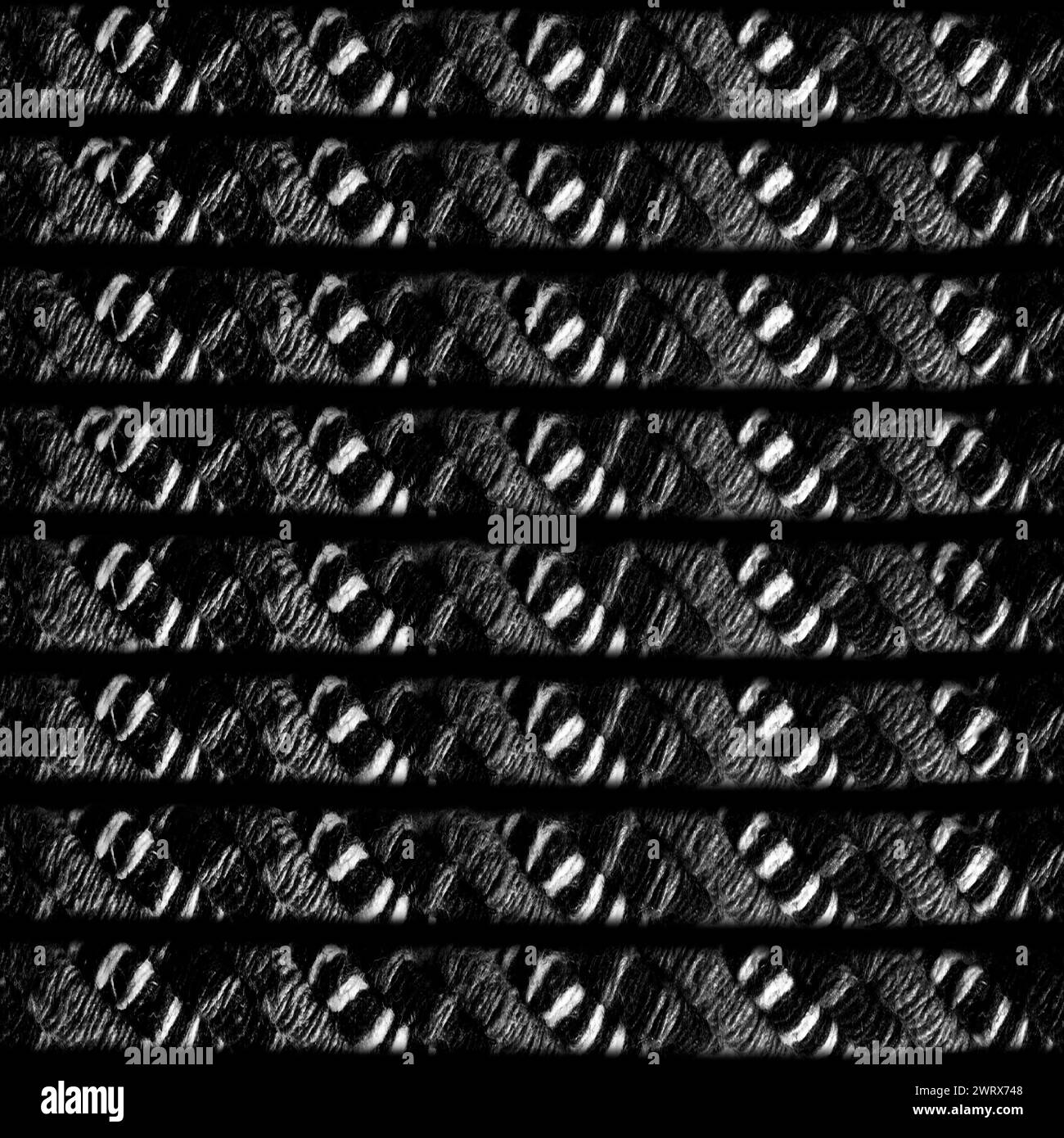 Photo de texture sans couture de corde ou de ceinture de laine tribale en niveaux de gris. Banque D'Images