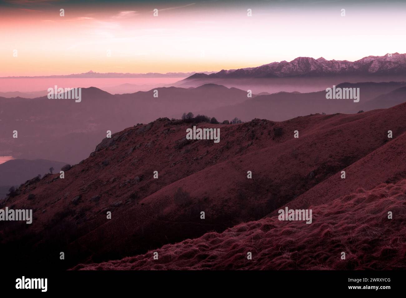 Coucher de soleil suggestif de la montagne Mottarone, avec Monviso en arrière-plan et chaîne de montagnes. Piémont - Italie Banque D'Images