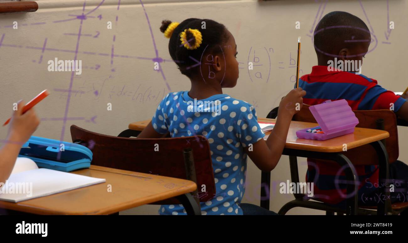 Image de formules mathématiques sur des enfants afro-américains apprenant à l'école Banque D'Images