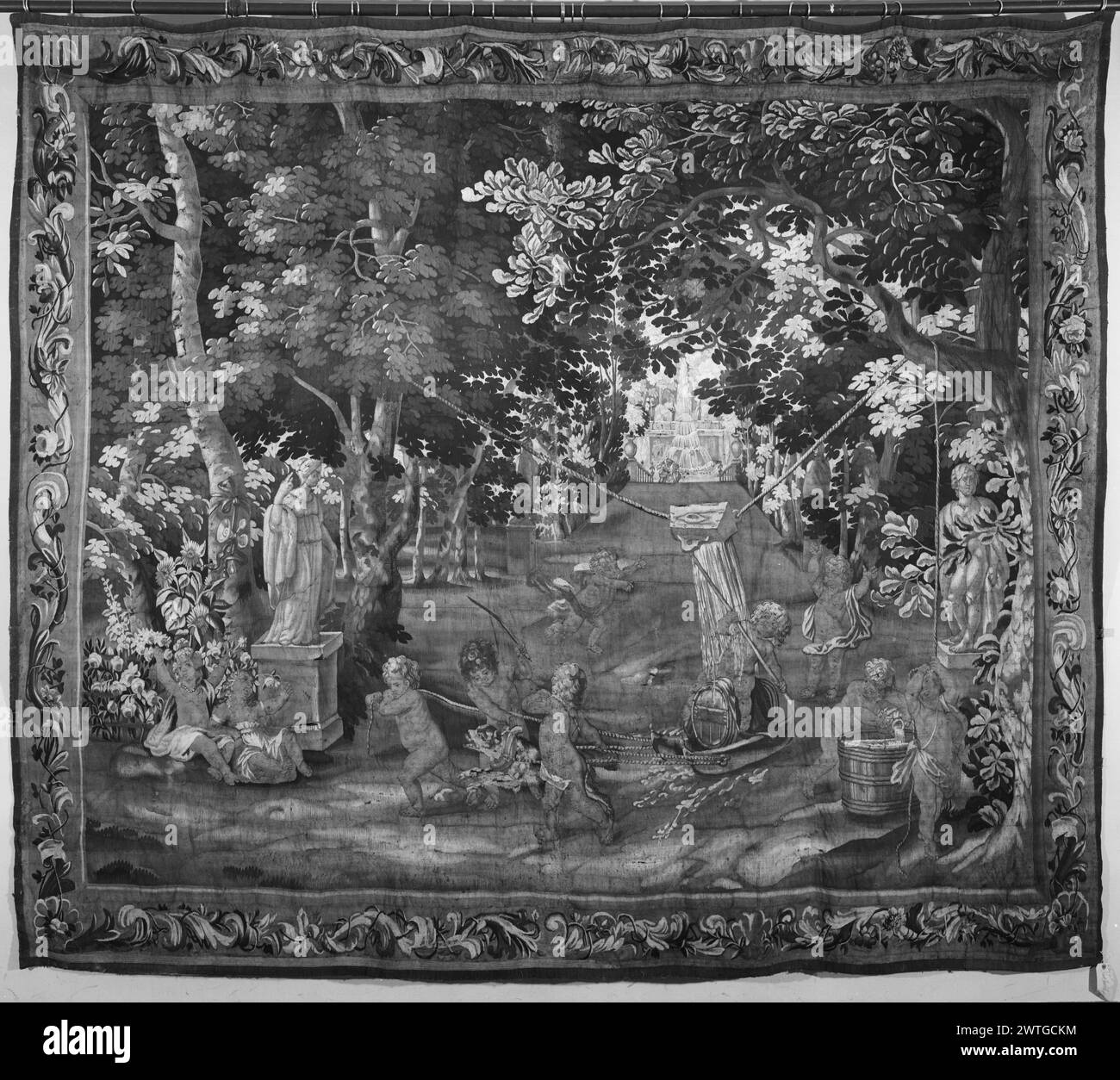 Enfants jouant à des jeux d'eau dans le parc de jardin. Inconnu c. 1690 dimensions de tapisserie : H 8'8' x l 10'2' matériaux/techniques de tapisserie : inconnu culture : Centre de tissage flamand : inconnu historique de propriété : Français & Co. acheté de Lyeman Corporation, reçu le 14/1964 ; vendu à V. & C. [Vigo & Charles] Sternberg le 4/30/1965. Seau d'eau sur corde suspendue à 2 arbres se vide sur l'enfant, baril de cheval sur le traîneau, ci-dessous comme d'autres enfants tirent le traîneau ; statue de la déesse sur l ; fontaine en distance (BRD) défilant feuilles d'acanthe avec fleurs Français & Co. feuille de stock dans les archives, H-104 Banque D'Images