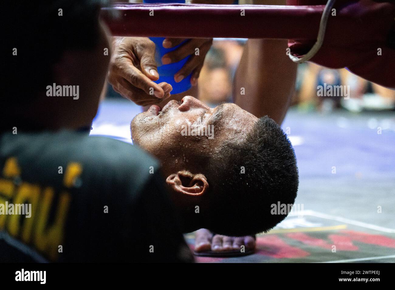 Un médecin retire le protège-dents du boxeur thaïlandais Petch si Nel, après avoir été assommé lors des combats de Muay Thai, sur l'île de Koh Chang, en Thaïlande. Banque D'Images