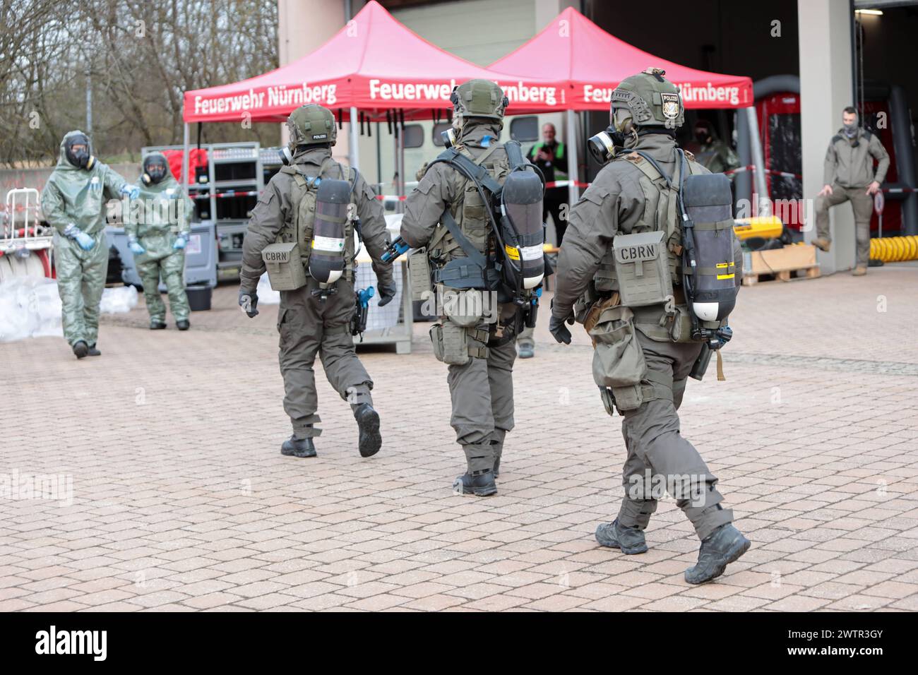 Angehörige des Spezialeinsatzkommandos der bayerischen Polizei SEK begeben sich in Schutzkleidung zu einer von der Feuerwehr eingerichteten Station zur Dekontaminierung von Personen, sog. Dékontamination CBRN. Länderübergreifende Großübung der Spezialeinheiten exercice de lutte contre le terrorisme CTE 2024. Sulzbach-Rosenberg Bayern Deutschland *** les membres du commandement des opérations spéciales de la police bavaroise en vêtements de protection se rendent à un poste mis en place par les pompiers pour décontaminer les personnes, ce qu'on appelle la décontamination CBRN exercice transnational majeur des unités spéciales Counter Terr Banque D'Images