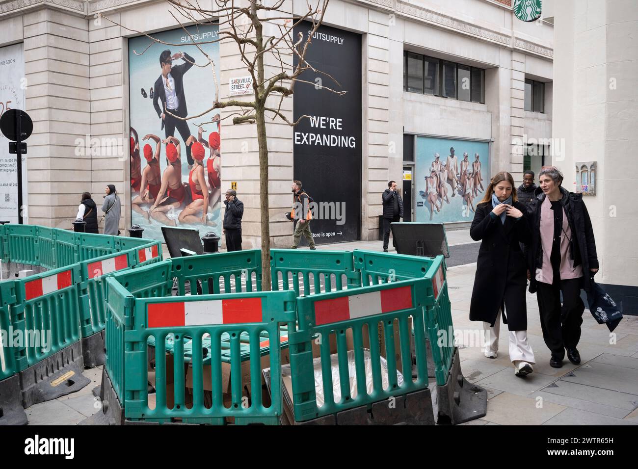 Les piétons traversent un paysage urbain de travaux routiers et de commerces de détail à l'angle des rues Sackville et Vigo à Mayfair, le 18 mars 2024, à Londres, en Angleterre. Banque D'Images