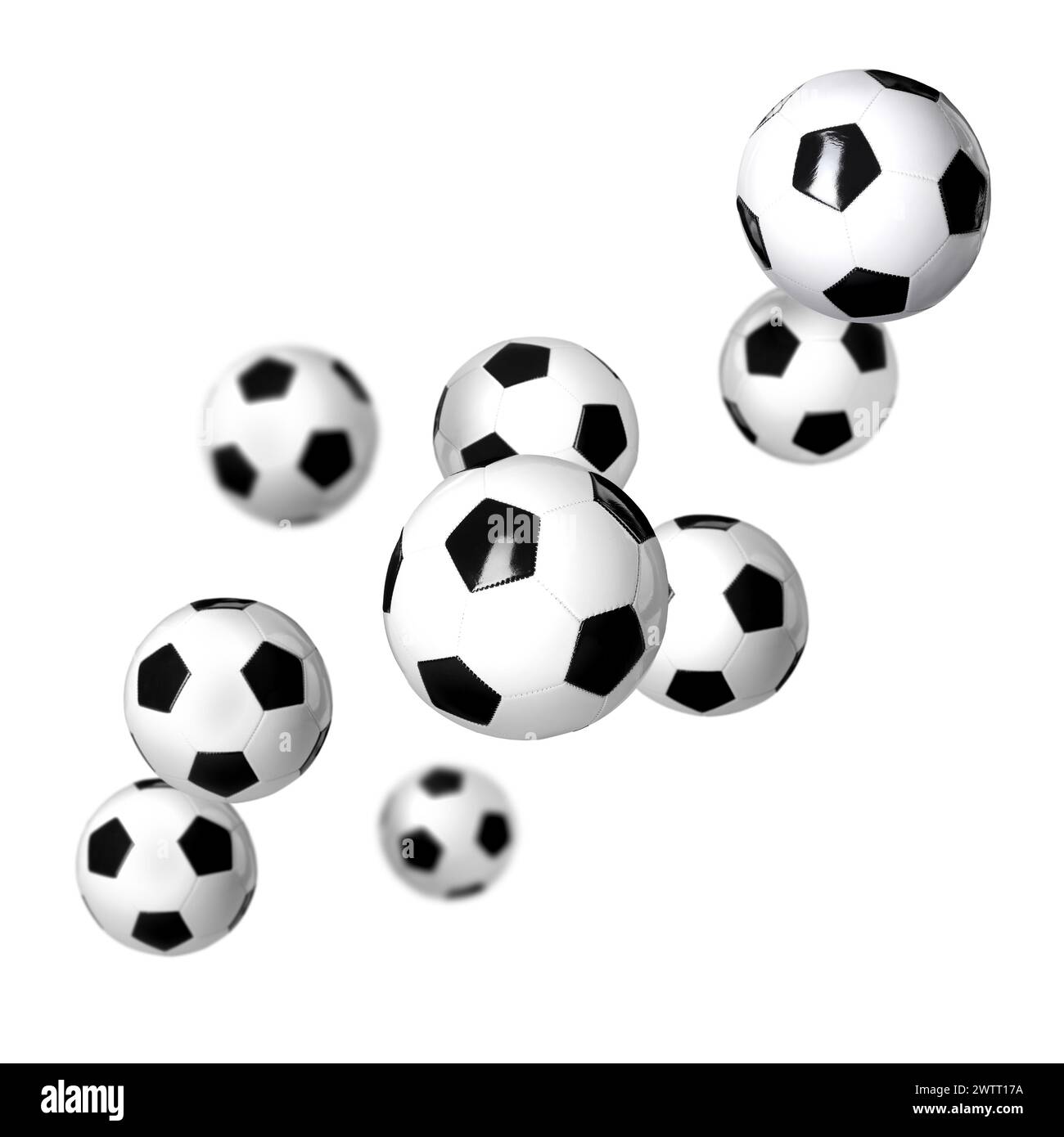 De nombreux ballons de foot qui tombent sur fond blanc Banque D'Images