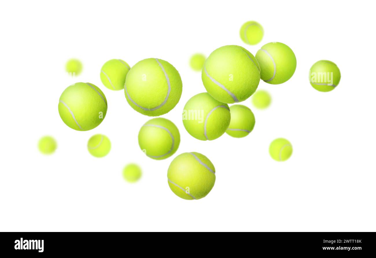 De nombreuses balles de tennis tombent sur fond blanc Banque D'Images