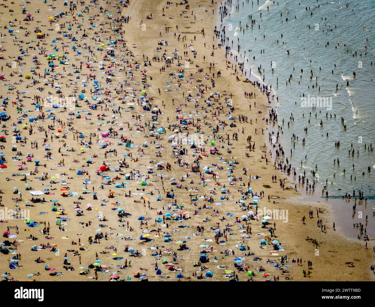 Une journée de plage occupée avec des foules profitant du soleil et de la mer Banque D'Images