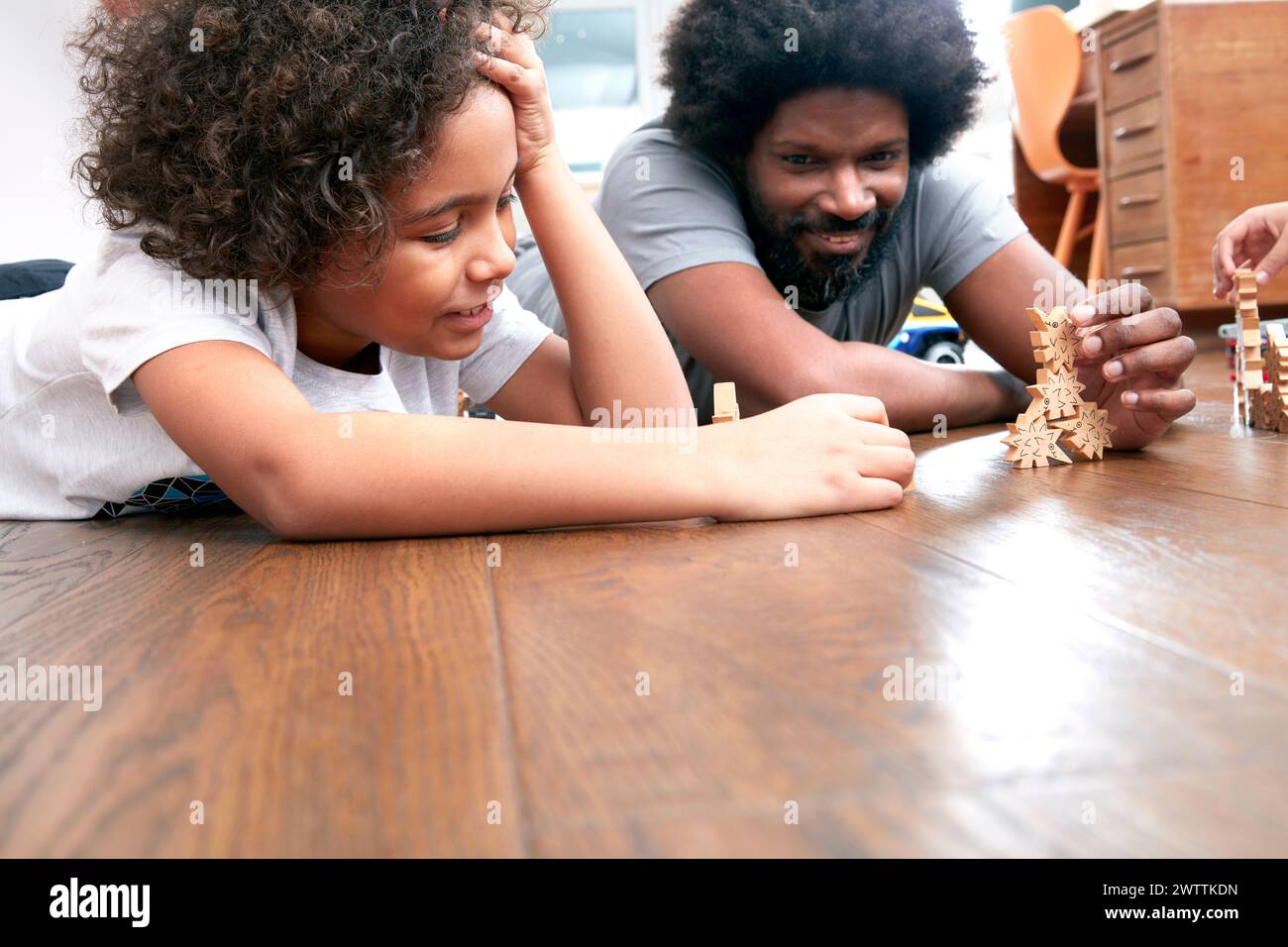Enfant et adulte jouant avec des pièces d'échecs en bois Banque D'Images