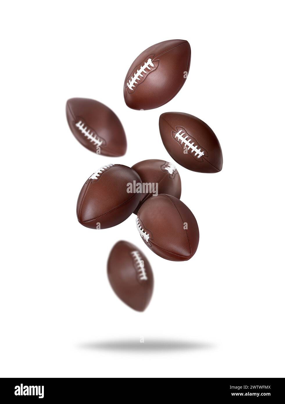 Balles de football américain tombant sur fond blanc Banque D'Images